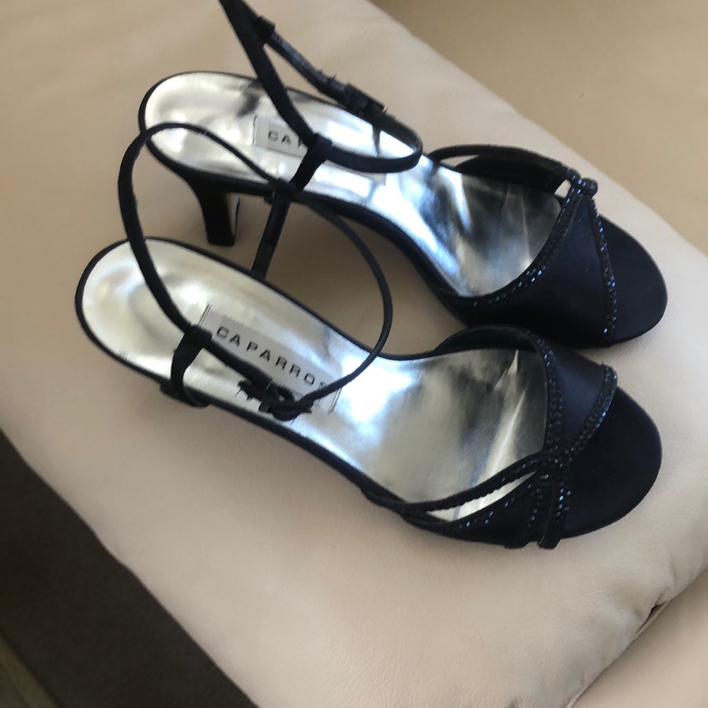 Dressy Navy Sandals Size 8W. Caparros brand. Heels measure 1 1/2” x 3”.